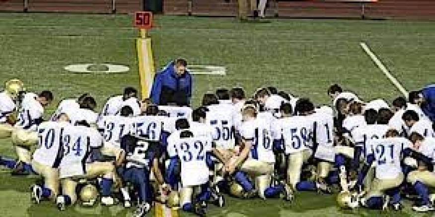 Coach Pharisee  and his entirely "voluntary" congregation, with no perceived pressure that they must pray to play.